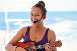 The crew on the Honolulu boat cruise sing and dance hula