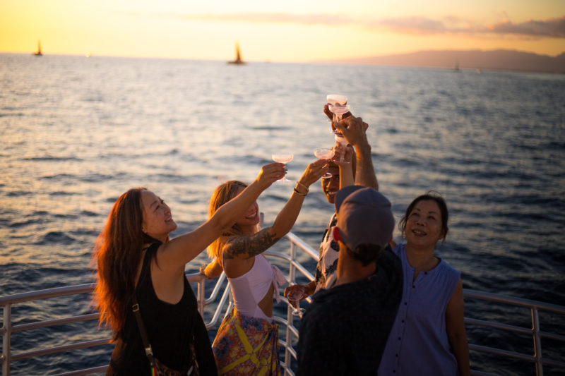Cheers with champaign on a Hawaii sunset cruise