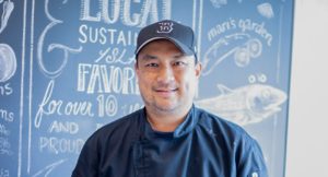 Local Chef Elmer Guzman serves island cuisine on an Oahu dinner cruise