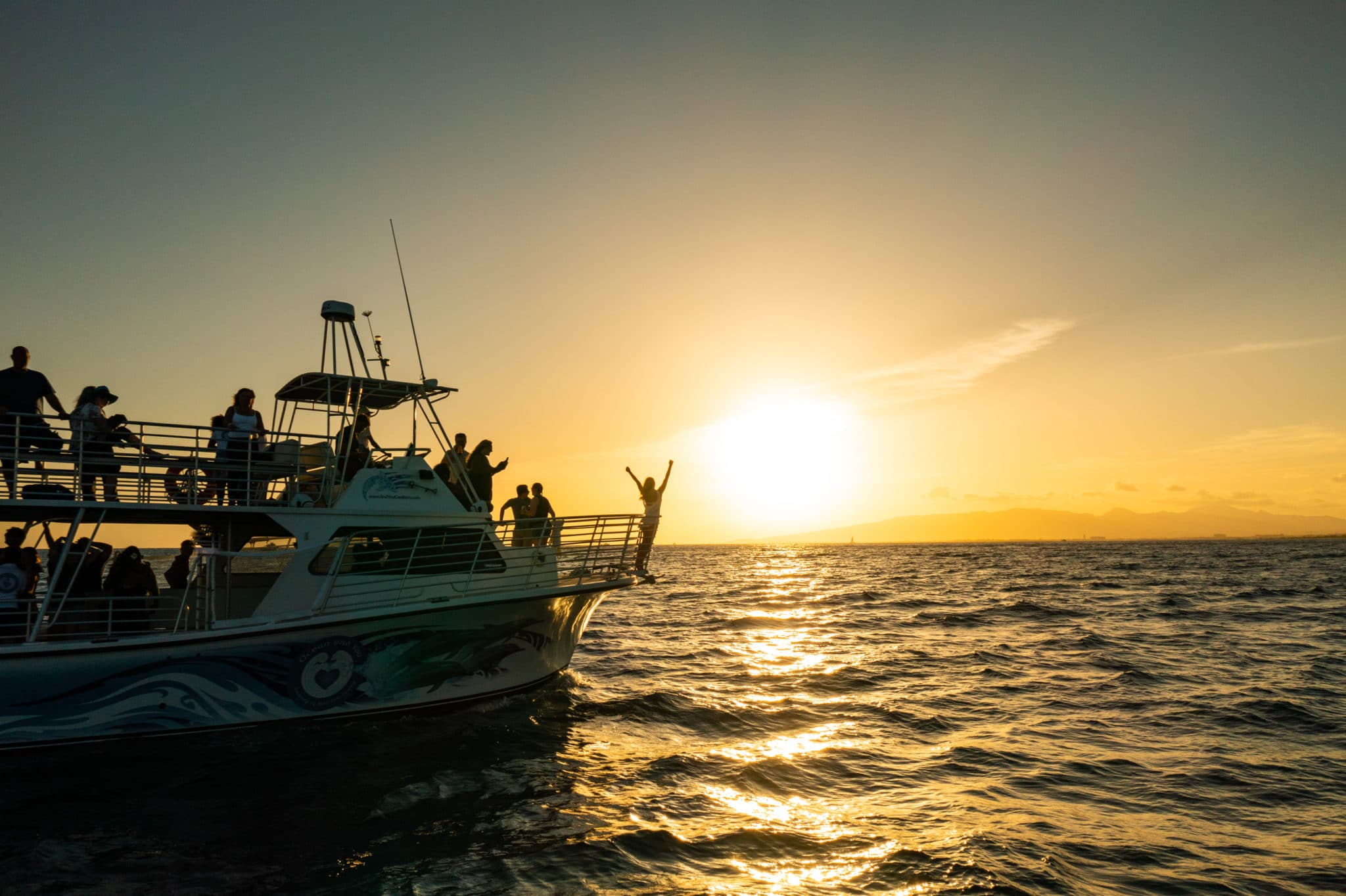 Ocean and You guest enjoys a sunset on Hawaii boat tour