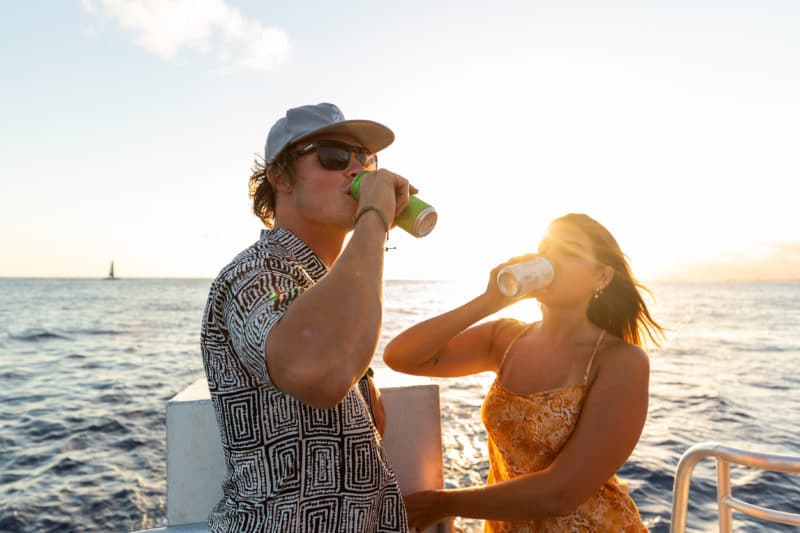 Visitors drink beer on a BYOB Waikiki boat tour