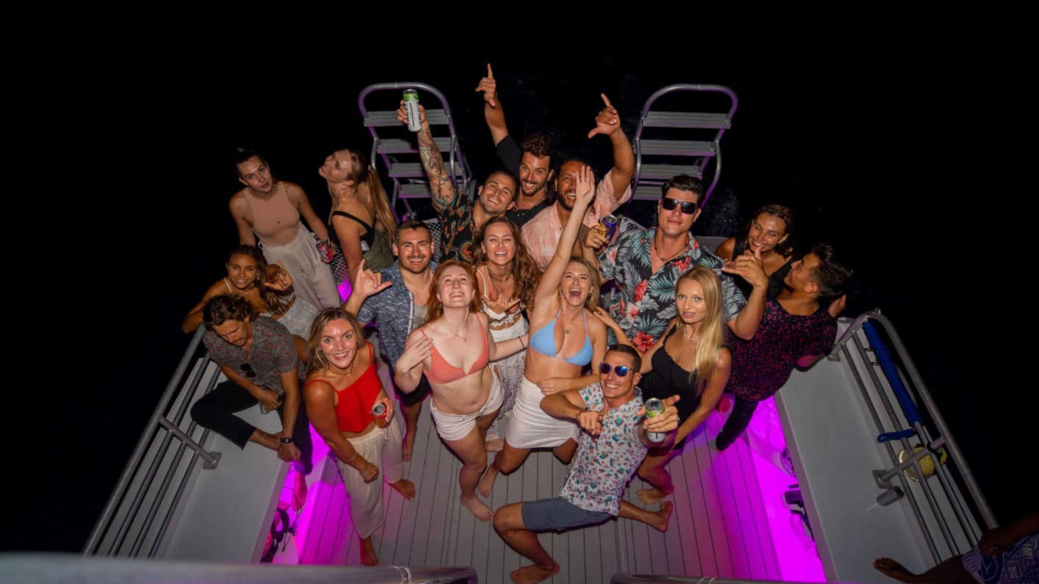 Guests dancing on the double-decker Waikiki New Year’s Eve Cruise under the night sky